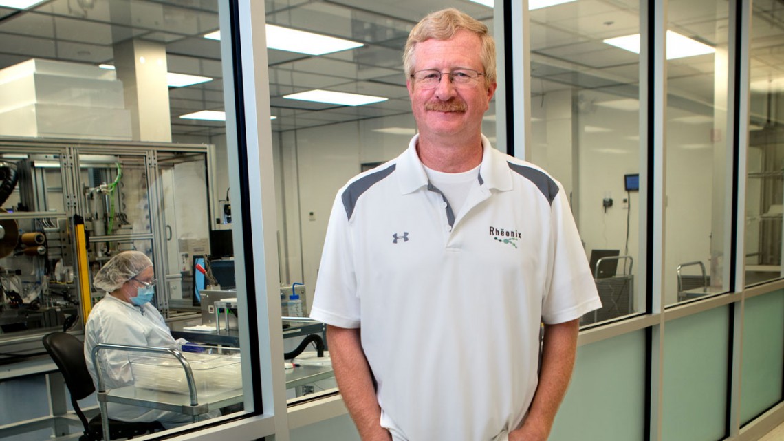 Greg Galvin, M.S. ’82, Ph.D. ’84, MBA ’93, founder and CEO of Rheonix, shown here in 2015, stands outside his lab