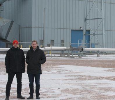 Jason Salfi, left, and Dr. David Erickson, right, of Dimensional Energy, are finalists in the Carbon XPRIZE. They stand in front of the Dry Fork Station coal-fired power plant in Gillette, Wyo., where the competition is located. Wyoming Public Radio